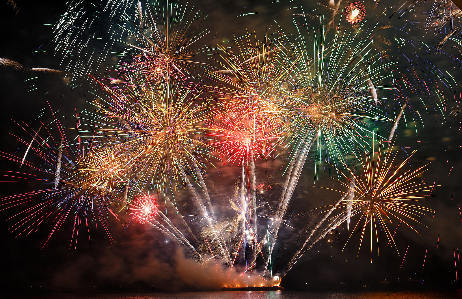 Gorgeous multi-colored fireworks display on dark blue night sky 