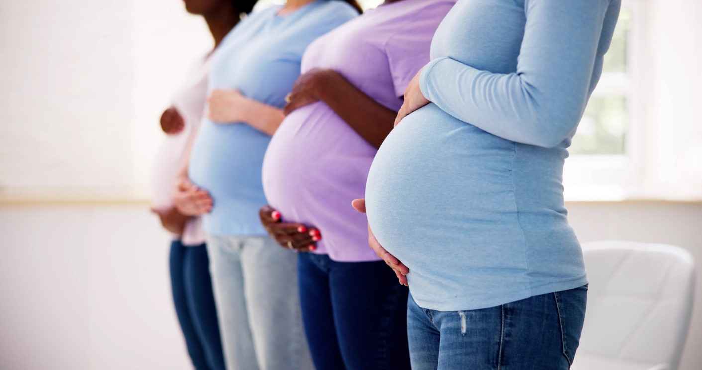 A group of pregnant women in a row
