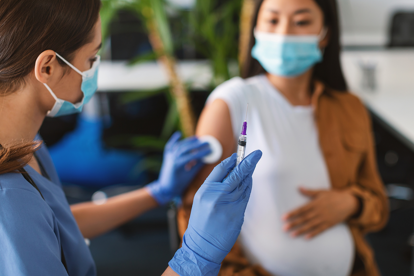 Pregnant woman getting prepared to have the Covid-19 vaccination